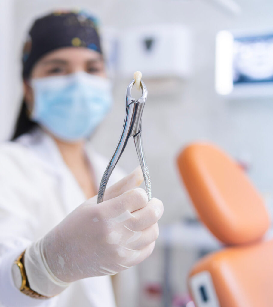 The doctor shows the extracted tooth.