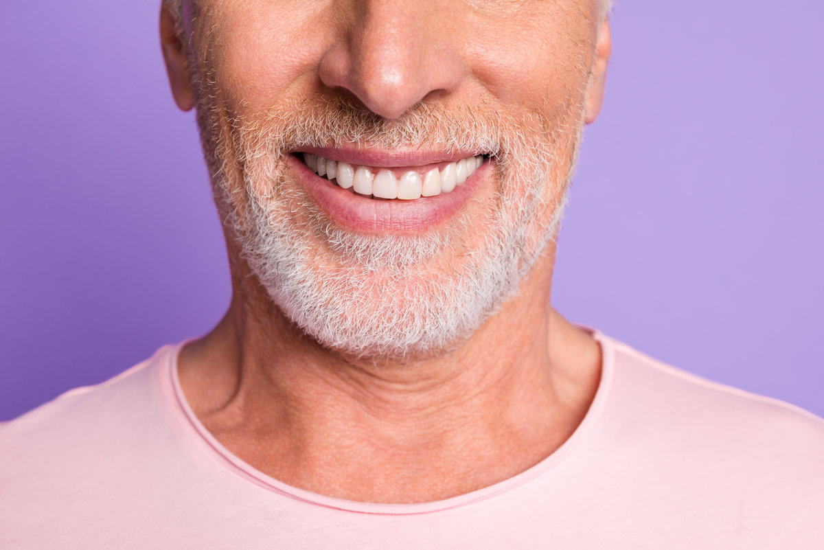 Cropped photo of pensioner old bristled man white beaming toothy smile wear pink t-shirt isolated purple color background.